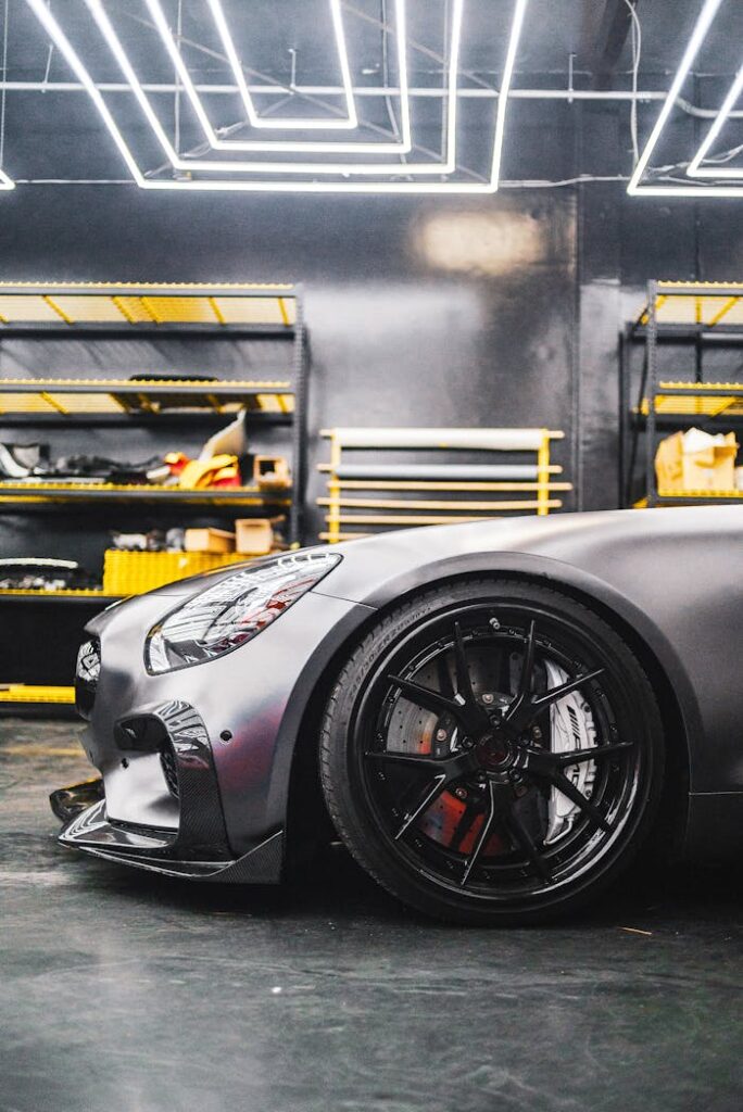 The Art of Drawing Readers In: Your attractive post title goes here Close-up of a sleek sports car in a contemporary garage environment with industrial lighting.